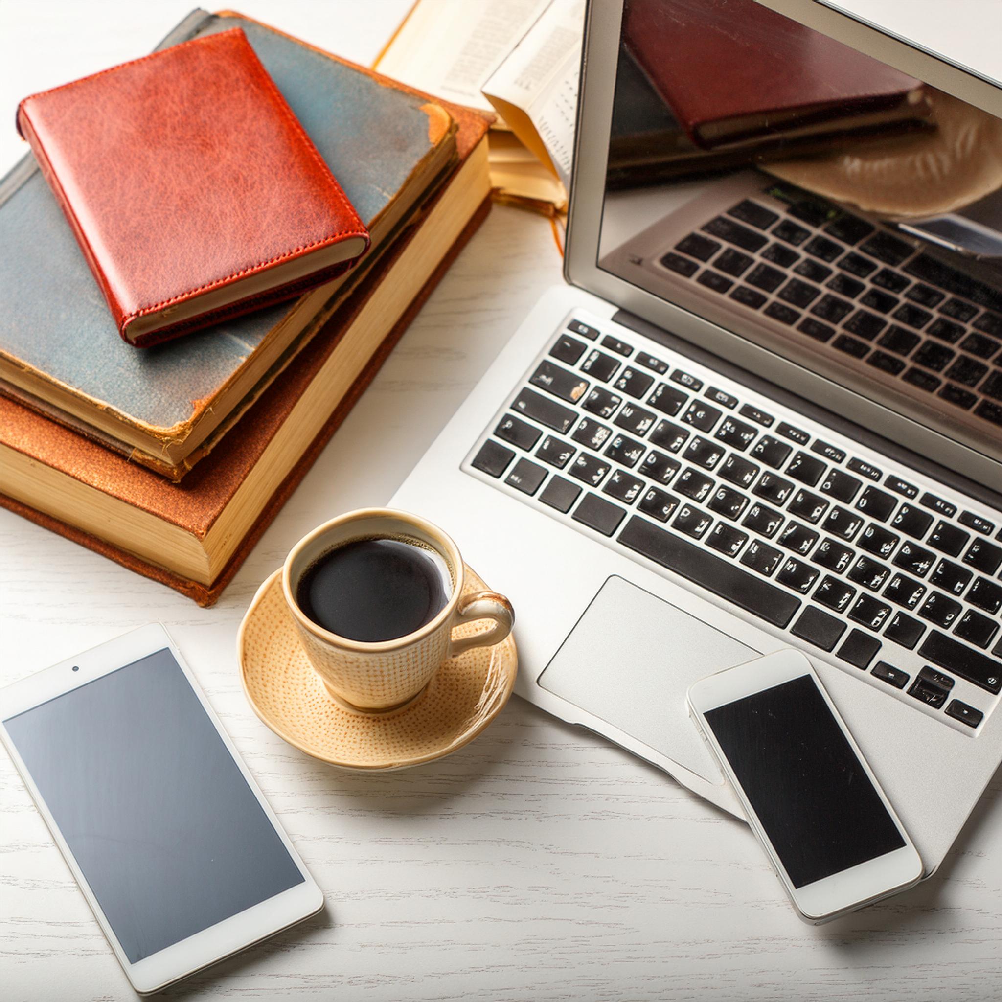 Firefly mobile phone, tablet and laptop; business workshop or work concept, white table with a coffe